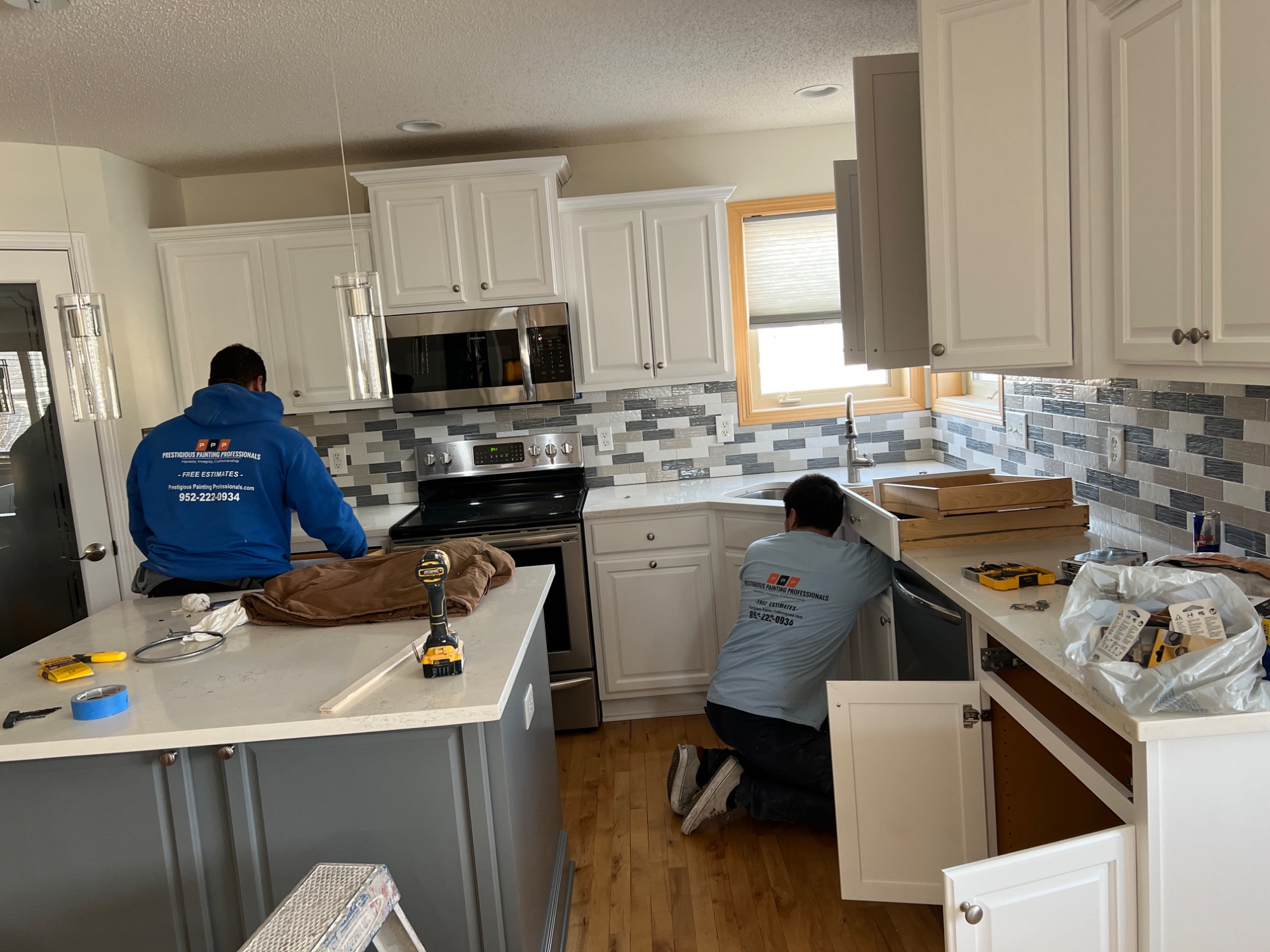 Crew working on kitchen cabinets